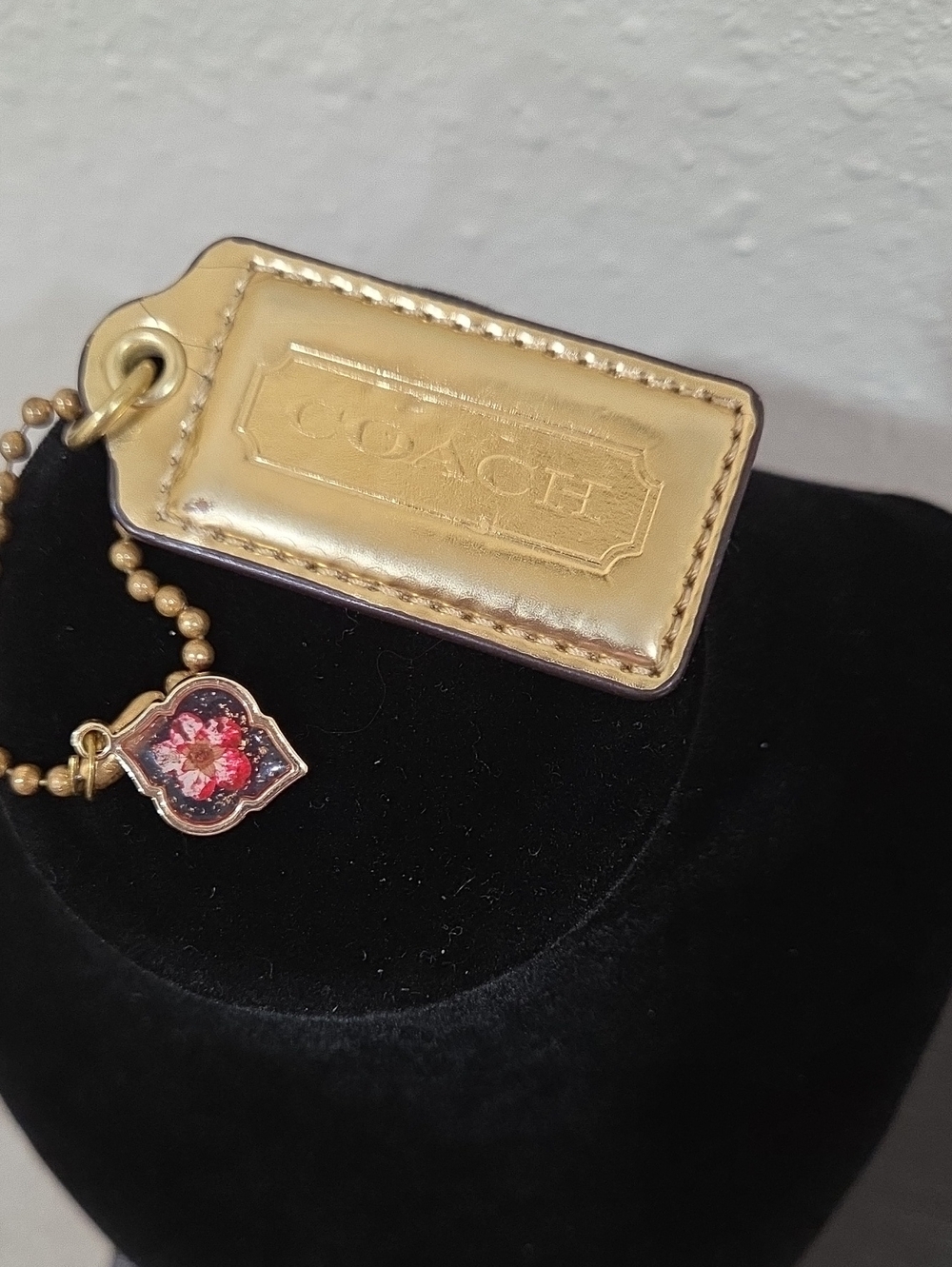 Coach Gold Leather Hangtag with Pink Dried Floral Charm